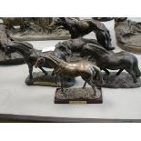 Three bronzed figures of horses and ponies