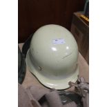 A folded rim German style helmet with flourescent band & neck brace as used by airport fire