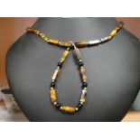 A tiger's eye bracelet and necklace with gold clasp