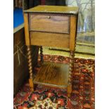 An oak sewing box on barleytwist legs