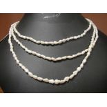 A three-strand pearl necklace on a .