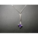 A 9ct chain with Deco-style diamond and amethyst pendant