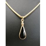 An 18ct chain and 9ct onyx pendant