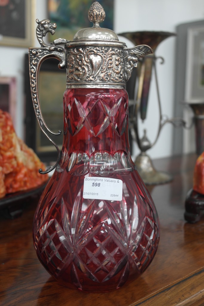 A cranberry cut crystal claret jug with Sheffield plate fittings,