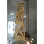 A 19th century ivory figure of a man with sword & dragon