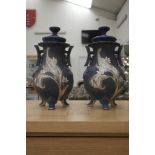 A pair of Chinese lidded urns with floral decoration on lapis lazuli-style ground
