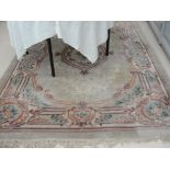 Large woolen rug with floral designs in greens,