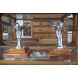 Two large Rolls Royce 'Spirit of Ecstacy' mascots on wooden stands