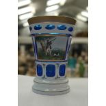 A Bohemian cut glass vase decorated with shooter and dog