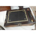 A 19th century brass-bound mahogany writing slope with black leather interior