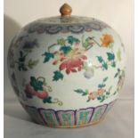 A 19th Century Chinese Famille Rose Jar With Lid:
the globular body decorated with a delicate motif