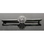 A Diamond Cluster Bar Brooch:
an unhallmarked 18ct gold bar brooch set with a large central old cut