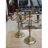 A pair of brass and copper three-sconce candelabra