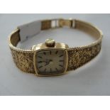 A ladies 9ct Omega wristwach on a 9ct gold strap