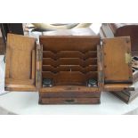 An Edwardian oak fold out stationary chest together with a mahogany writing slope writing slope