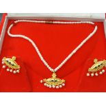 A 22ct gold and pearl necklace and earring set