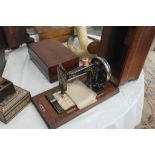 A vintage sewing machine in a Tunbridgeware case