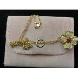 An 18ct diamond and ruby set floral pendant on an 18ct chain