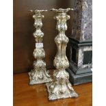 A 19th century white metal Continental pair of candlesticks