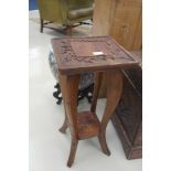 A Chinese hardwood jardiniere stand carved with prunus decoration