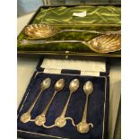 A cased set of white metal serving spoons;