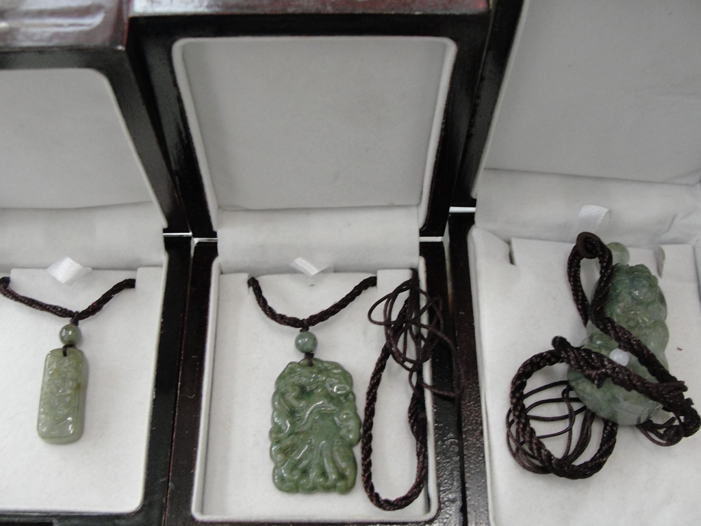 Three hardstone pendants