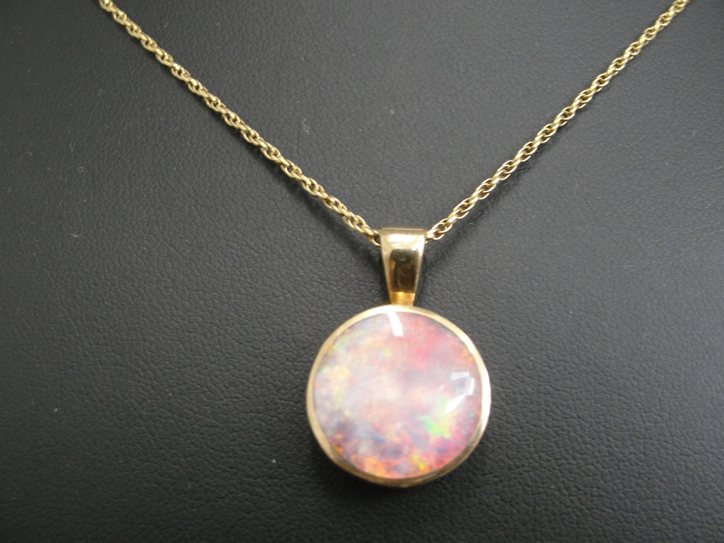 A 9ct chain and large backed opal pendant