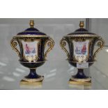 A pair of Royal Crown Derby lidded urn vases in cobalt blue and gilt decoration