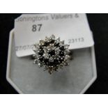 A black and white diamond cluster ring