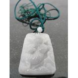 A Pale Green Jadeite Pendant:
depicting a tiger in undergrowth