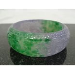 A Jadeite Green and Lilac Bangle with Engraved Decoration