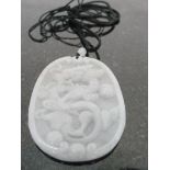 A Pale Green Jadeite Pendant:
carved with dragon and flaming pearl