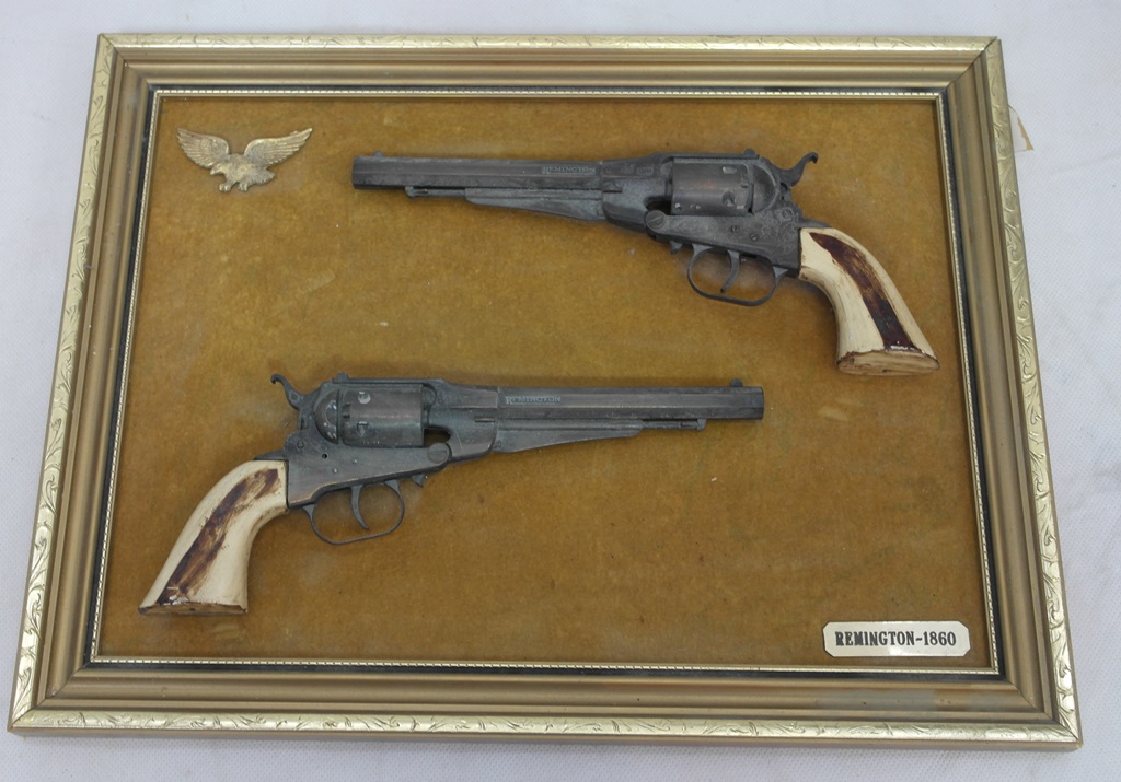 A framed wallpiece of a pair of 1860 Remington pistols