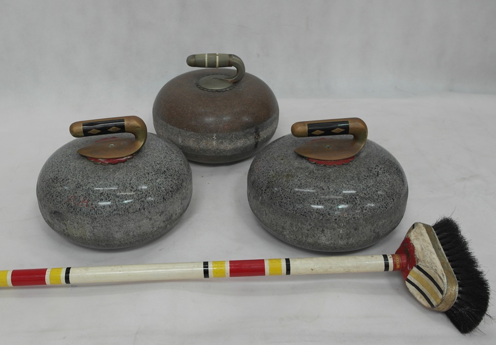 Three curling stones;