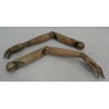 A pair of articulated wooden arms