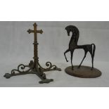 A scrollwork wrought iron crucifix;