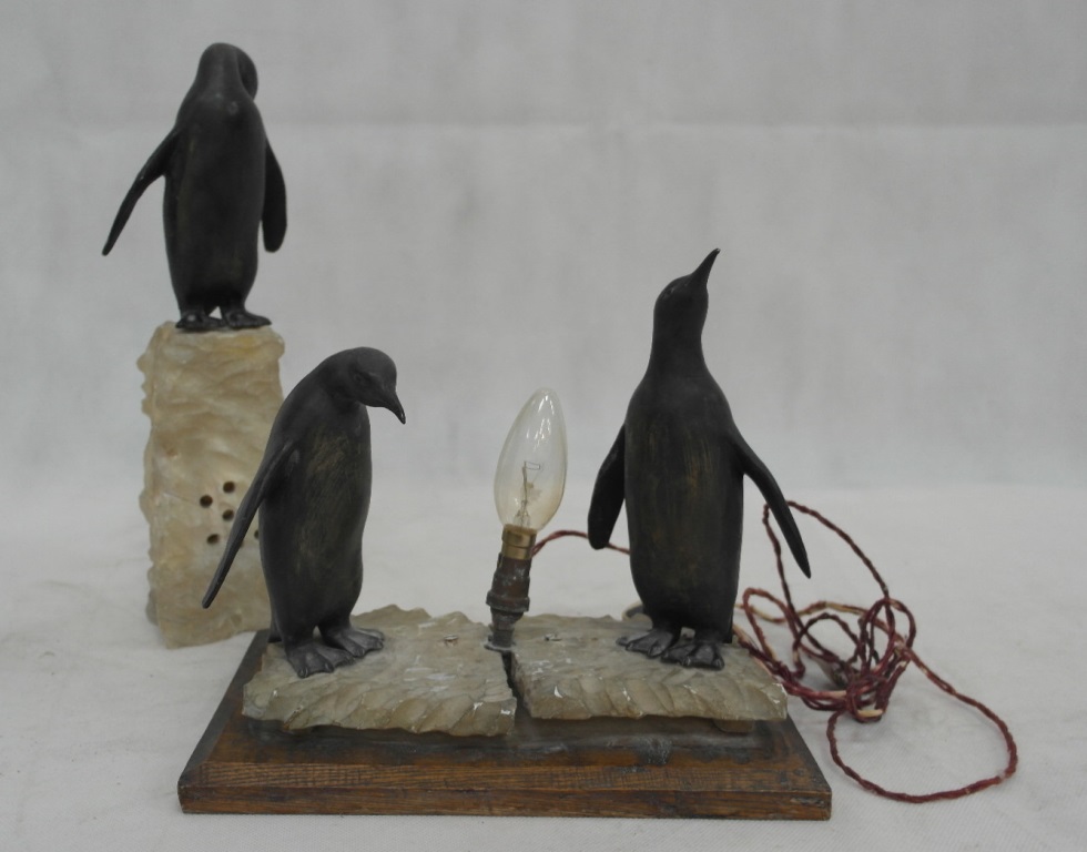 Vintage bronzed penguins lamps on stone bases
