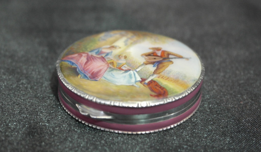 A Continental 935 silver pill box, the silver engine turned box with pink enamel to the sides,