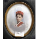 Continental School (19th/20th century): A portrait miniature of a figure in a red cap, signed,