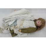 A 19th century German articulated doll with clothes and spares;