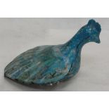 A Persian turquoise glazed cockerel, with stylized black script.