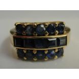 An 18k triple row blue stone dress ring