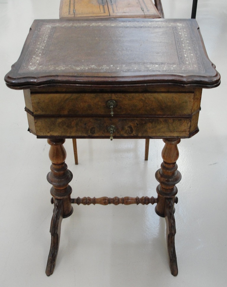 A victorian burr walnut leathered top twist top writing desk