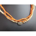 A coral necklace with a 9ct clasp;