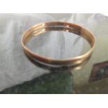 A 9ct gold bangle