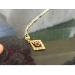 A 9ct ruby and diamond pendant on chain