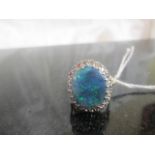 An 18ct large "Millionaires Gully" Australian mined black opal ring with Diamond surround