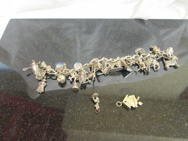 A silver charm bracelet and charms