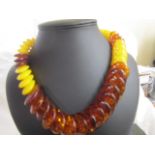 A Lemon Amber and Amber necklace in disc form