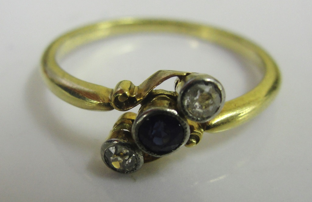 An 18ct Edwardian diamond and sapphire trilogy ring